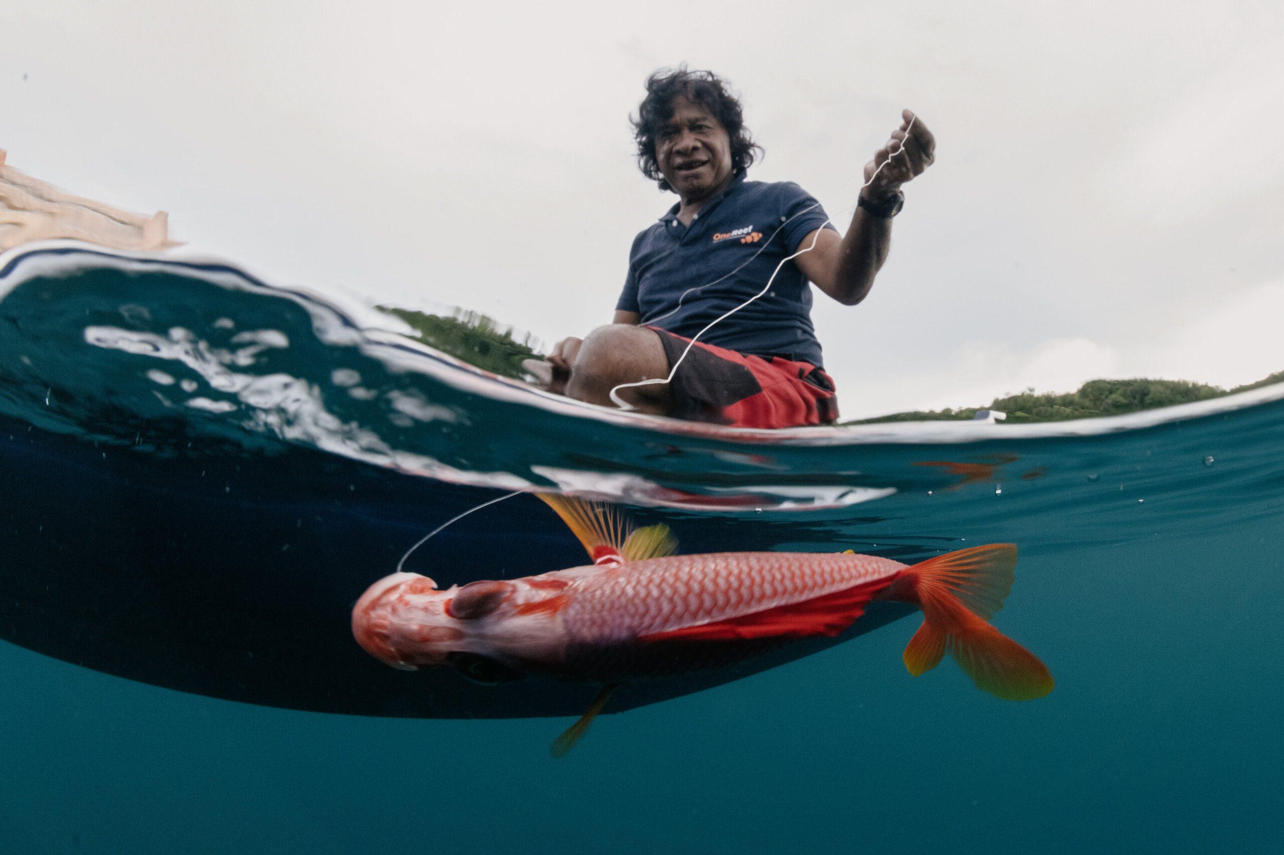 Master navigator Akilino Alvis fishes for reef fish in the lagoon near Echang village, Palau, using a traditional SW Islander technique known as stone fishing. Akilino is an elder keeping this traditional knowledge alive to pass down to future generations, including the knowledge of building traditional outrigger canoes and sailing them.